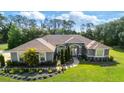 Charming single-story home featuring lush landscaping, verdant lawn, and a welcoming front entrance at 2659 Hibbard Trl, Chuluota, FL 32766