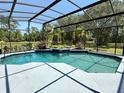 Inviting screened-in pool with a unique in-pool garden feature, creating a serene outdoor oasis at 2659 Hibbard Trl, Chuluota, FL 32766