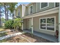 Comfortable two-story home exterior with a covered front porch and a charming yard at 283 Woodgreen Ln, Winter Springs, FL 32708
