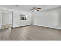 Spacious living room featuring modern laminate flooring, neutral paint, and ample natural light at 283 Woodgreen Ln, Winter Springs, FL 32708