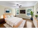 Bright bedroom features hardwood floors, a ceiling fan, and large windows offering natural light at 306 Foxboro Ct, Lake Mary, FL 32746
