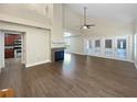 Spacious living room with wood floors, vaulted ceiling, and view to the kitchen area at 306 Foxboro Ct, Lake Mary, FL 32746