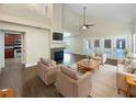 Bright living room with wood floors, neutral walls, and a fireplace with large glass doors to backyard at 306 Foxboro Ct, Lake Mary, FL 32746