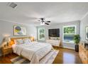 Comfortable main bedroom with hardwood floors, a ceiling fan, and natural light at 306 Foxboro Ct, Lake Mary, FL 32746