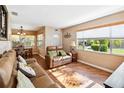 Cozy living room featuring hardwood floors, a comfortable sofa, and large windows at 3118 Walnut St, Winter Haven, FL 33881