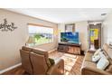 Comfortable living room with wood floors, neutral walls, and plenty of natural light at 3118 Walnut St, Winter Haven, FL 33881