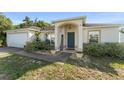 Inviting single-story home with well-maintained landscaping, a welcoming front entrance, and a cozy atmosphere at 3270 Courtland Blvd, Deltona, FL 32738