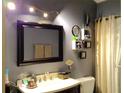 Well-lit bathroom with a large mirror, modern vanity, updated lighting, and neutral paint at 3312 Bridgeford Dr, Orlando, FL 32812