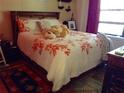 Cozy bedroom featuring a bed with floral pattern bedding and plush pillows near a bright window at 3312 Bridgeford Dr, Orlando, FL 32812