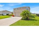 Well-kept two-story home featuring a two-car garage and manicured front lawn at 356 Quarry Rock Cir, Kissimmee, FL 34758