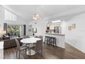Open-concept living area with a dining table, breakfast bar, and balcony access, perfect for entertaining at 3900 Southpointe Dr # 127, Orlando, FL 32822