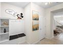 Bright foyer features stylish built-in storage, unique lighting, and decorative wall art at 4314 Lana Ave, Davenport, FL 33897