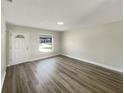 Bright living room featuring a large window, neutral paint, and modern flooring at 472 Little Aspen Ct, Ocoee, FL 34761
