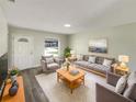Cozy living room featuring a plush rug, comfortable seating, and stylish decor at 472 Little Aspen Ct, Ocoee, FL 34761