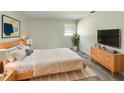 Comfortable bedroom with a queen-sized bed, modern decor, and a serene ambiance at 472 Little Aspen Ct, Ocoee, FL 34761