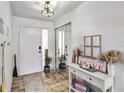 Welcoming foyer with tiled floor, closet with mirrored doors, and ample natural light at 4930 Gifford Blvd, Orlando, FL 32821