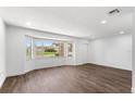 Spacious living room with wood floors, a large window, and recessed lighting at 611 Lakespur Ln, Altamonte Springs, FL 32714