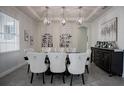 Bright dining area featuring pendant lighting, seating for eight, and unique wine storage for both aesthetics and functionality at 7536 Green Mountain Way, Winter Garden, FL 34787
