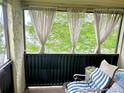 Relaxing screened in balcony with a comfortable lounge chair and peaceful view of greenery at 912 Lake Destiny Rd # F, Altamonte Springs, FL 32714