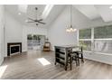 Bright living room featuring vaulted ceilings, skylights, fireplace and sliding door access at 950 Vanessa Ct # F, Port Orange, FL 32127