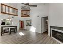 Open-concept living area with high ceilings, wood floors, fireplace and serving area at 950 Vanessa Ct # F, Port Orange, FL 32127