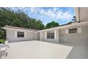 The exterior of a single story home with white paint, white framed windows and a grey roof at 103 Longhorn Rd, Winter Park, FL 32792