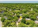 An aerial view showcases this home surrounded by verdant trees and a large neighborhood at 112 Brandywine Ln, Longwood, FL 32779
