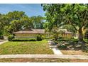 Charming single-story home with stone facade and a well-maintained lawn and walkway at 112 Brandywine Ln, Longwood, FL 32779