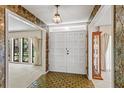 Inviting foyer with tile flooring, double doors, and decorative wallpaper, offering a glimpse into spacious living areas at 112 Brandywine Ln, Longwood, FL 32779
