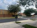 Street view with crosswalk, landscaping, and surrounding buildings at 1122 Priory Cir, Winter Garden, FL 34787