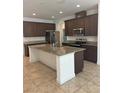 Spacious kitchen island with granite countertops and stainless steel appliances at 14741 Milfoil Ave, Orlando, FL 32827