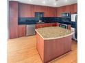 Modern kitchen with granite countertops, stainless steel appliances, and dark backsplash tile at 155 S Court Ave # 2008, Orlando, FL 32801