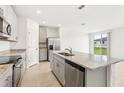 Open kitchen with a large island, granite countertops, and stainless steel appliances at 1737 Forest Run Ln, Auburndale, FL 33823