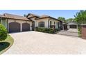 A stucco house has a tile roof, a two-car garage, a brick entry gate, and a paved driveway at 1741 Palmer Ave, Winter Park, FL 32789