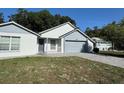 Charming single-Gathering home with a well-manicured front yard, brick driveway, and an attached two-car garage at 2009 Nottingdale Ln, Winter Park, FL 32792