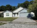Charming single-Gathering home with a well-manicured front yard, brick driveway, and an attached two-car garage at 2009 Nottingdale Ln, Winter Park, FL 32792