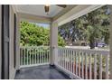 Serene front porch with white railing and views of lush greenery, ideal for enjoying the neighborhood at 2028 Donegan Pl, Orlando, FL 32826