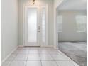 Inviting foyer with tile flooring and a modern front door at 2061 Rush Bay Way, Orlando, FL 32824