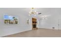 Bright living room featuring a brick fireplace, hardwood floors, and modern light fixtures at 2460 Worthington Rd, Maitland, FL 32751
