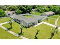 This single-story home has a fenced yard and palm trees in the front at 2471 Greenwood St, Deltona, FL 32738