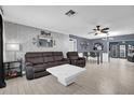 This living room features tile floors, gray paint, modern furniture, and recessed lighting at 2471 Greenwood St, Deltona, FL 32738