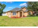 Beautiful exterior view of home with tidy lawn and landscaping highlighting the architecture at 2619 Breezy Meadow Rd, Apopka, FL 32712