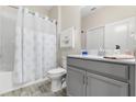 Bright bathroom featuring a shower-tub combo, white and grey vanity, and nautical decor at 3007 Caneel St, Winter Haven, FL 33884