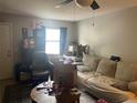 Cozy living room with couch, ceiling fan, neutral color palette, and a window providing natural light at 3347 Timberline W Rd, Winter Haven, FL 33880