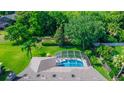 Aerial view of a screened in pool, surrounded by lush greenery and foliage at 341 Sprucewood Rd, Lake Mary, FL 32746