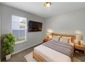 This bright bedroom features a wall-mounted TV and a cozy neutral color scheme at 4010 Brookshire Cir, Eustis, FL 32736