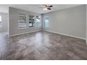 Spacious living room with neutral tile flooring and large windows offering ample natural light at 4010 Brookshire Cir, Eustis, FL 32736