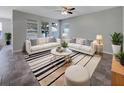 Stylish living room with white sofas, striped rug, and plenty of natural light at 4010 Brookshire Cir, Eustis, FL 32736