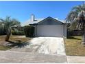 Home featuring an attached two-car garage and a spacious driveway for ample parking at 549 Silvergate Loop, Lake Mary, FL 32746