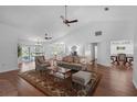 Bright and airy living room featuring a vaulted ceiling, hardwood floors, and stylish decor at 633 N Longview Pl, Longwood, FL 32779